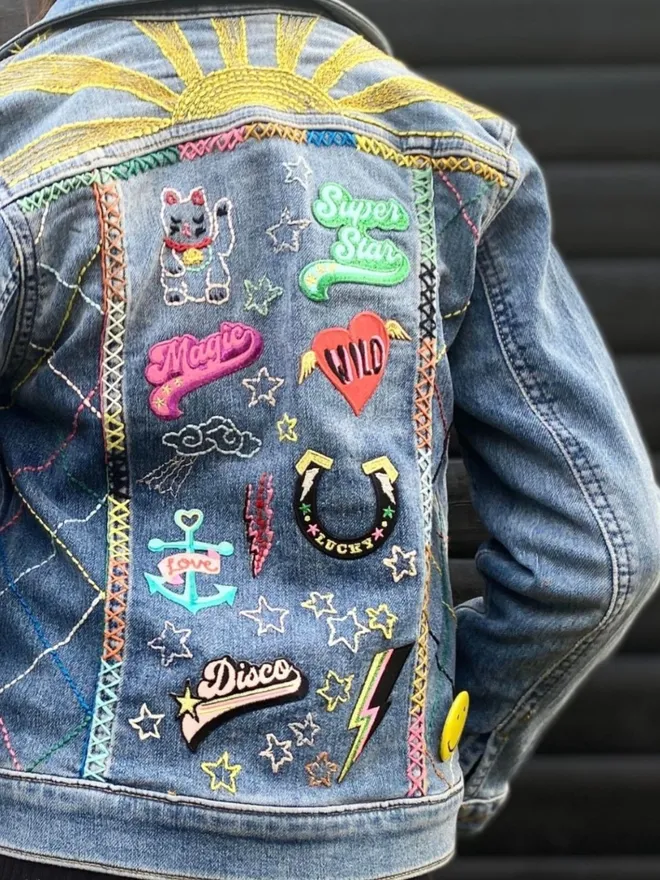 Kids hand embroidered denim jacket with patches.