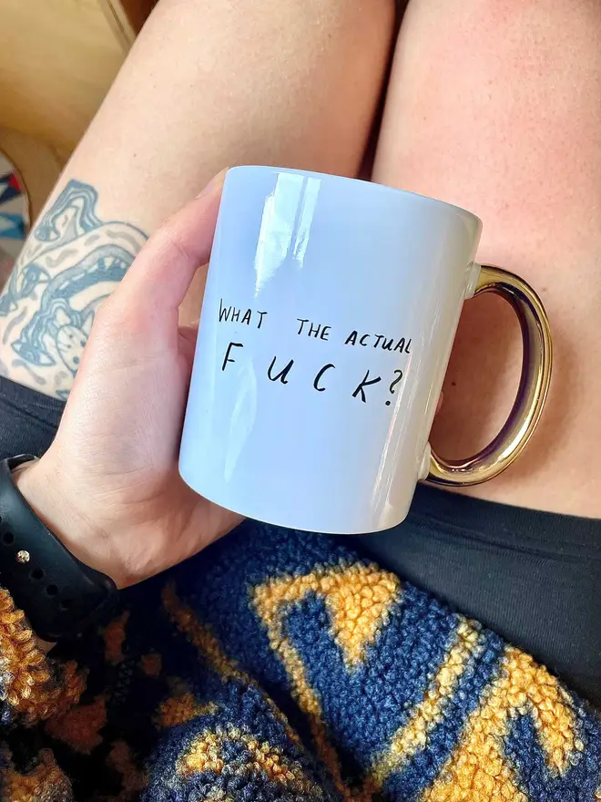 Holding mug in lap 