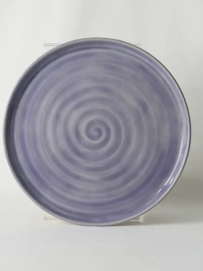 purple ceramic cake plate with textured swirl design