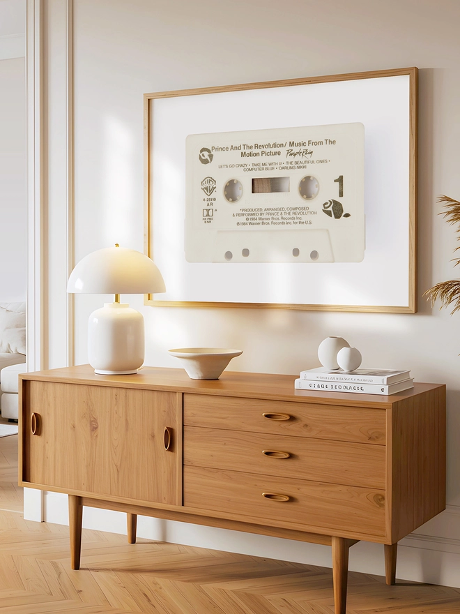 prince purple rain cassette tape print. framed print hung above wooden dresser.