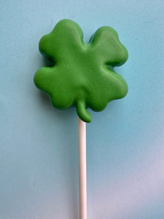 st patrick's day lucky clover cake pops (pack of 3). a green clover cake pop on a stick.