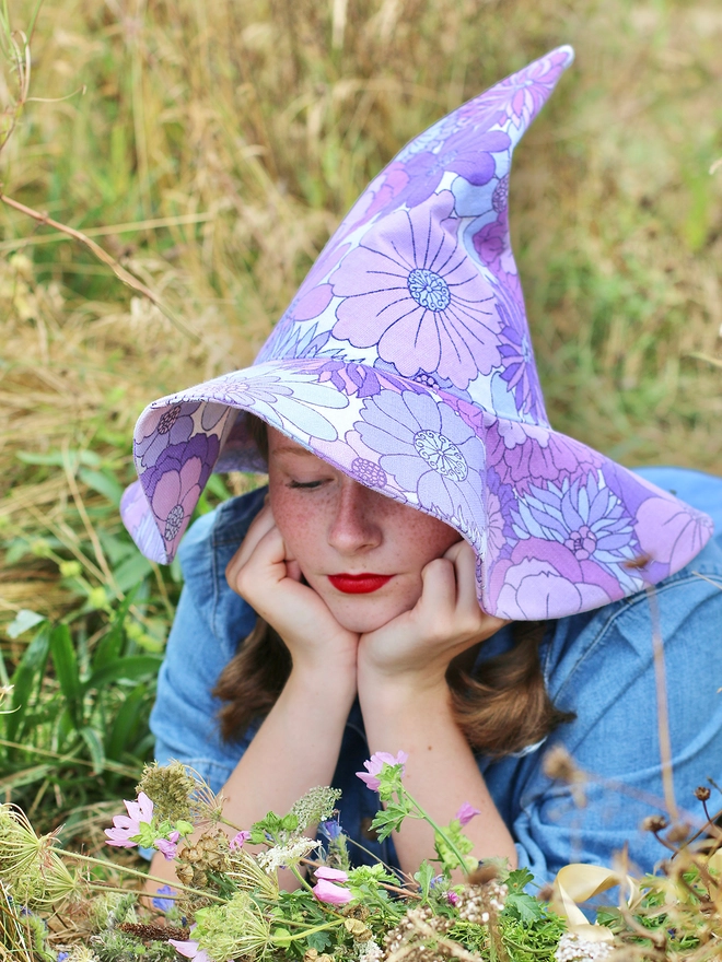 Girl in field wearing handmade vintage fabric witch hat