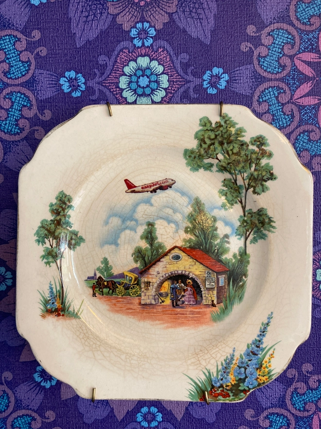 vintage plate featuring a couple getting married in a chapel at Gretna Green while an easyJet plane flies overhead.