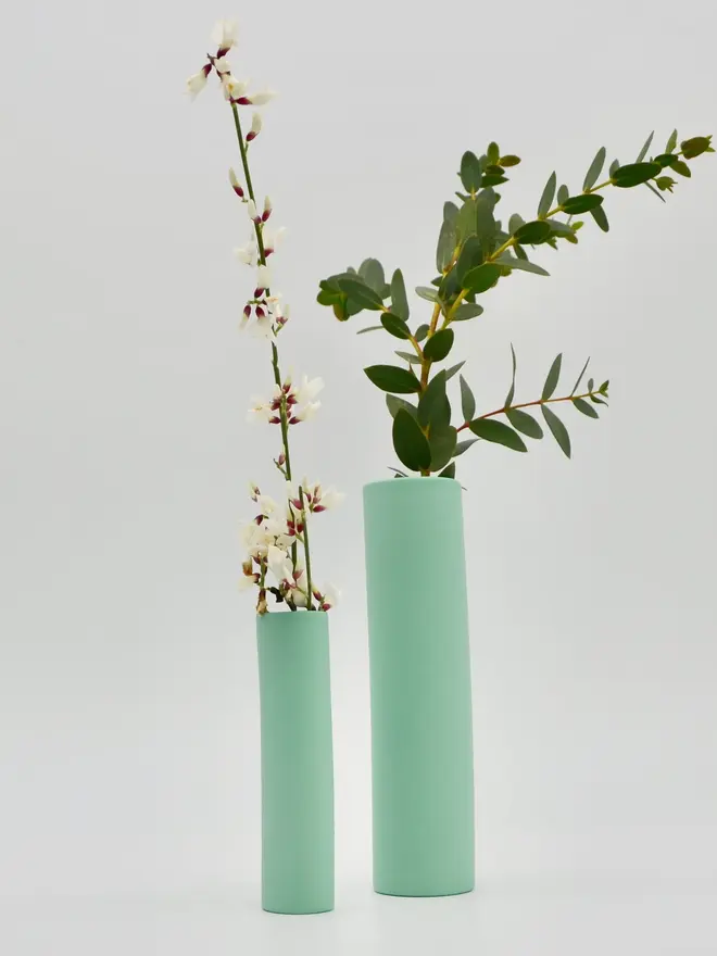 2 green stem vases with flowers