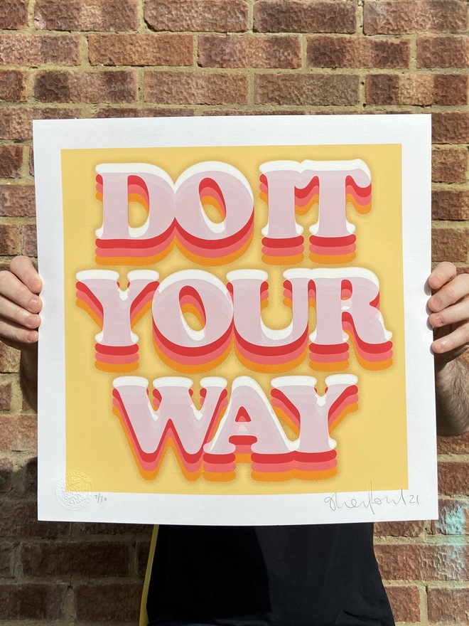 "Do It Your Way" Hand Pulled Screen Print square with yellow cream background and the words do it your way printed on top with shades of orange layers and a brown outline glow 