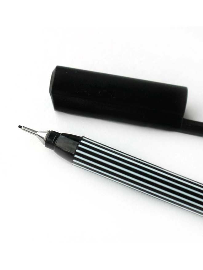 Close up of a Black Edding Fineliner with the lid off.