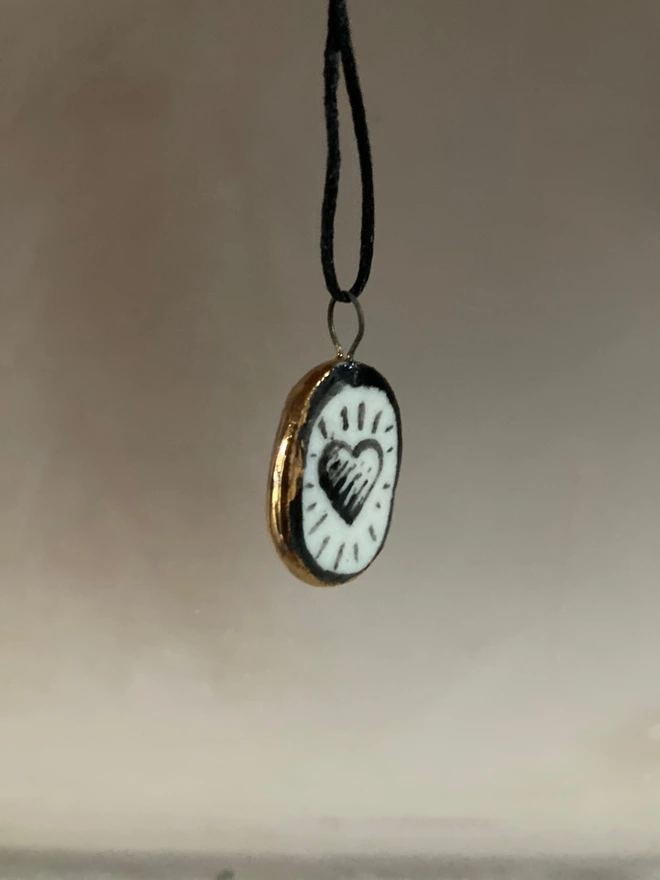 porcelain heart pendant hanging gold sides showing