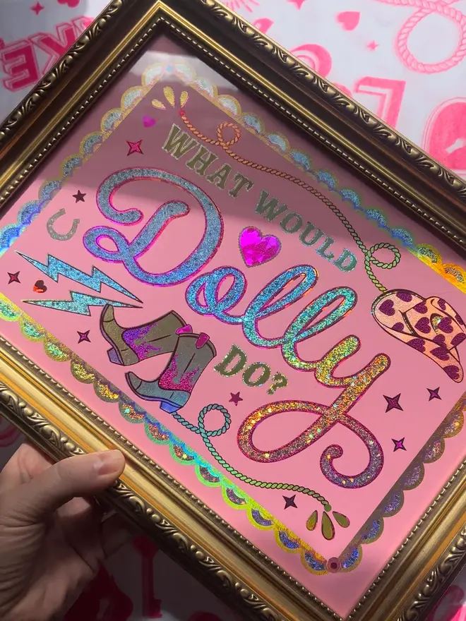 'What Would Dolly Do?' ScreenPrint, a colourful screenprint that says 'what would Dolly do?' sitting on a decorated surface. 