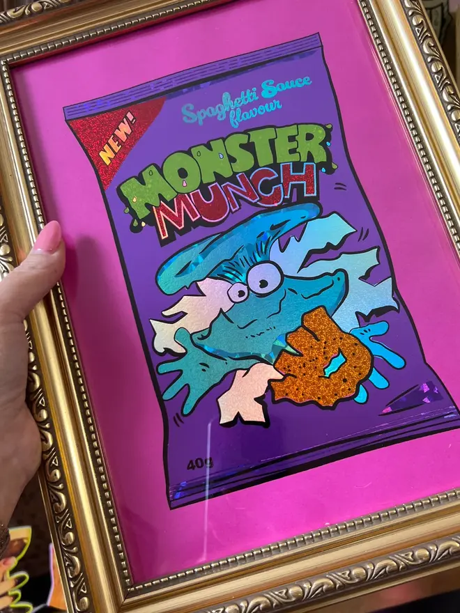 'Monster Munch' Spaghetti ScreenPrint, a person holding a colourful monster munch themed print. 