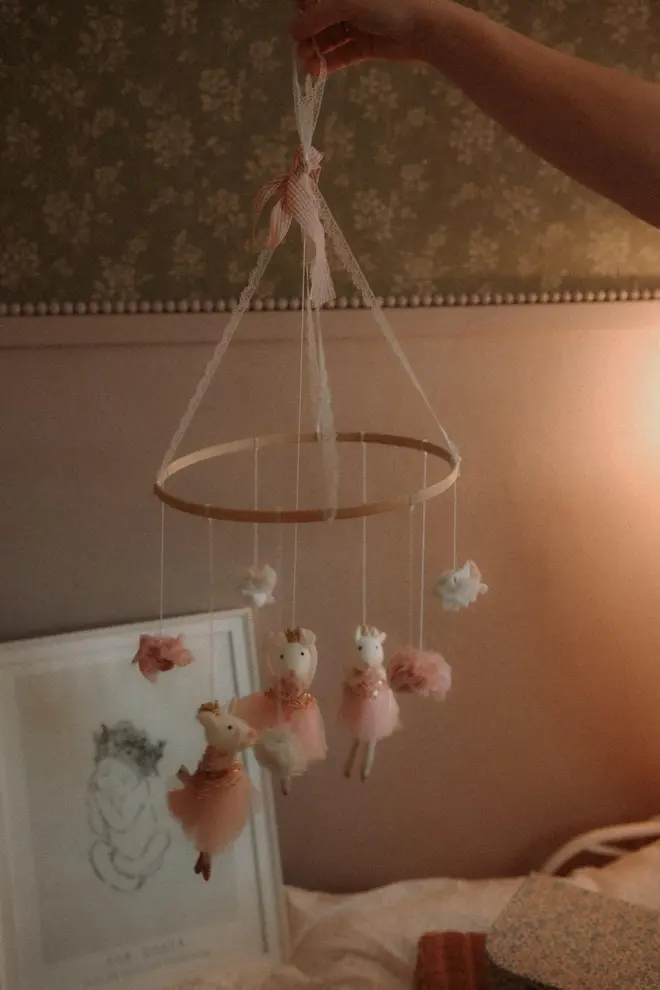 Hanging Mice Ballerina Felt Carousel Decoration, a hanging mice carousel decoration suspended in a child's decorated bedroom. 
