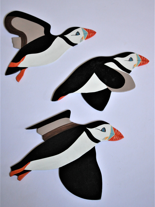 Wooden flying puffins