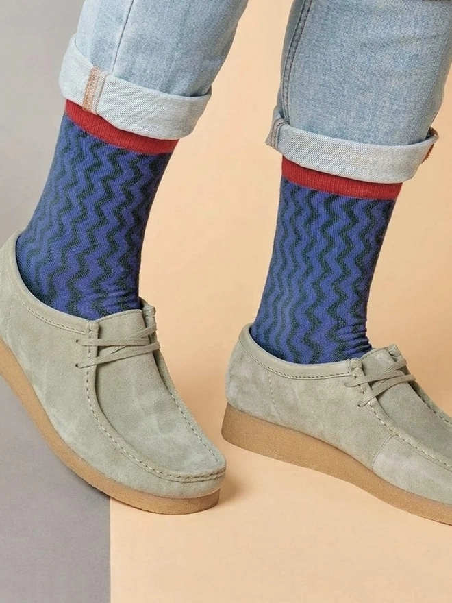 Men's Organic Cotton Ankle Socks Packs (Sets Of 3), a man wearing a pair of colourful patterned socks. 