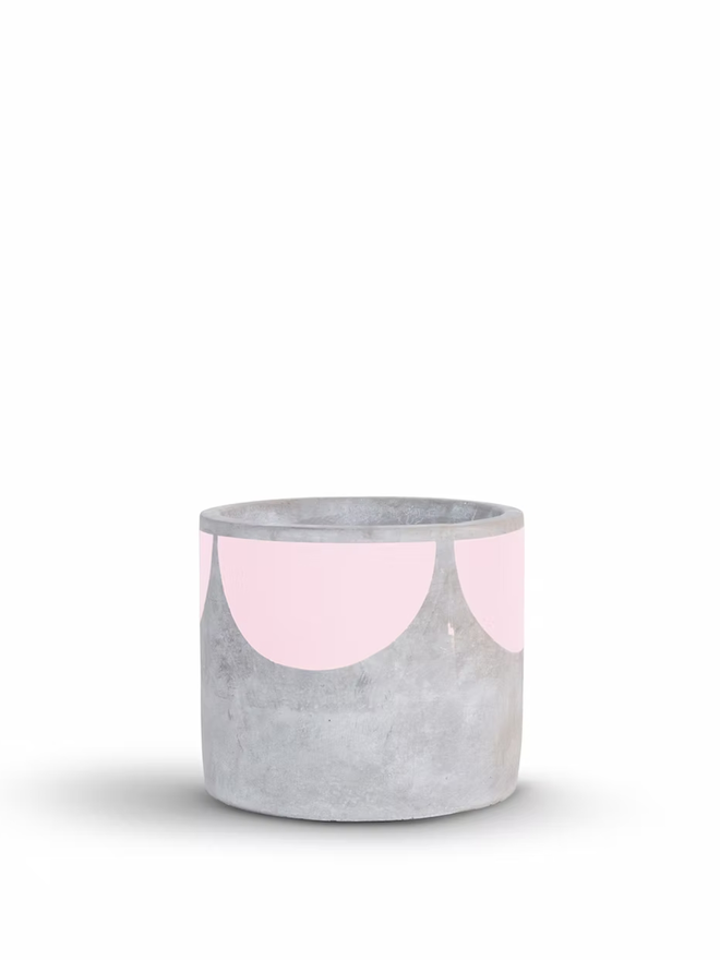 sunny concrete plant pot. a grey plant pot with a pale pink half sun pattern painted around the top rim.