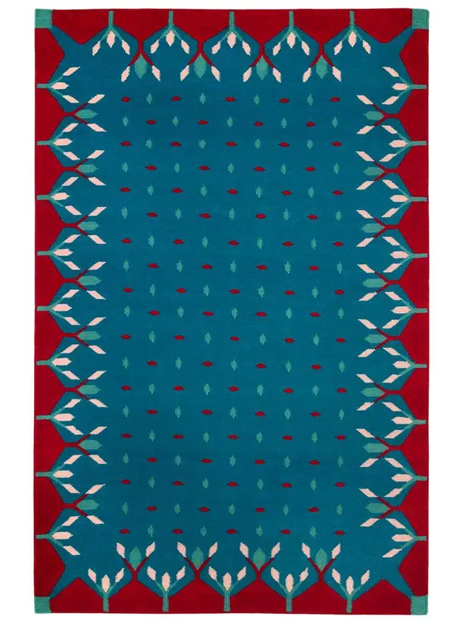 Hedgerow Flatweave Rug, a colourful rug sitting on a plain backdrop. 