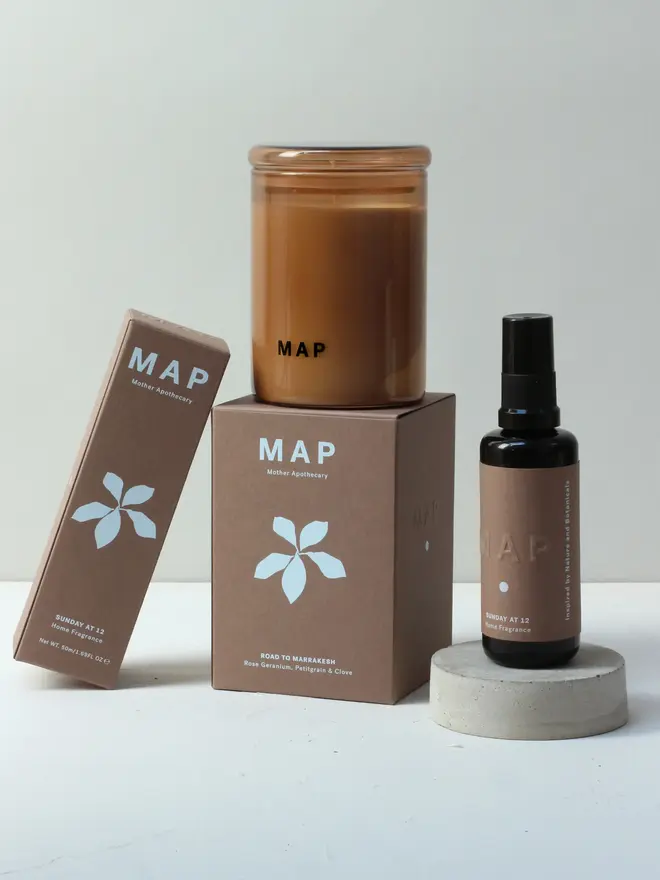 calm aromatherapy candle and home fragrance spray set. gift set and boxes photographed against white studio backdrop. 