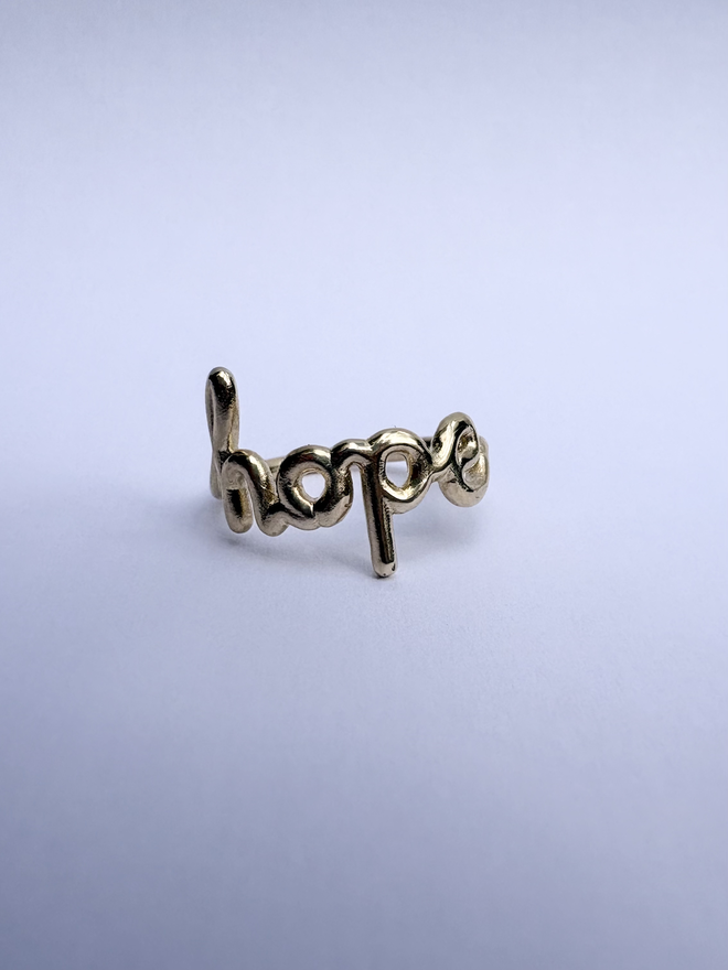 Ring that says 'Hope' within it, in 9ct yellow gold