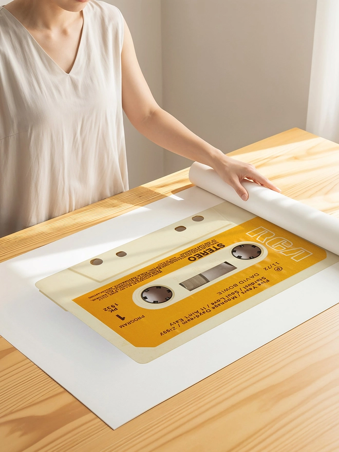 david bowie rise and fall of ziggy stardust cassette print. print being unrolled on wooden desk.