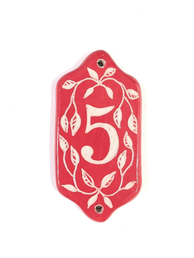 Red Sgraffito Leaf Address Tile. A tile with ‘5’.