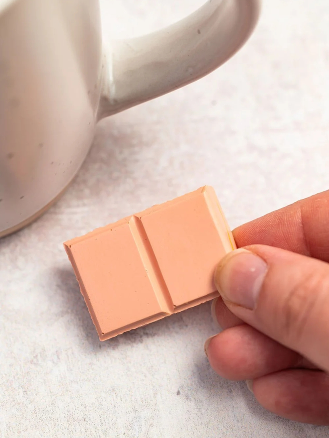 ceramic chocolate magets. a ruby pink chocolate magnet photographed close up.
