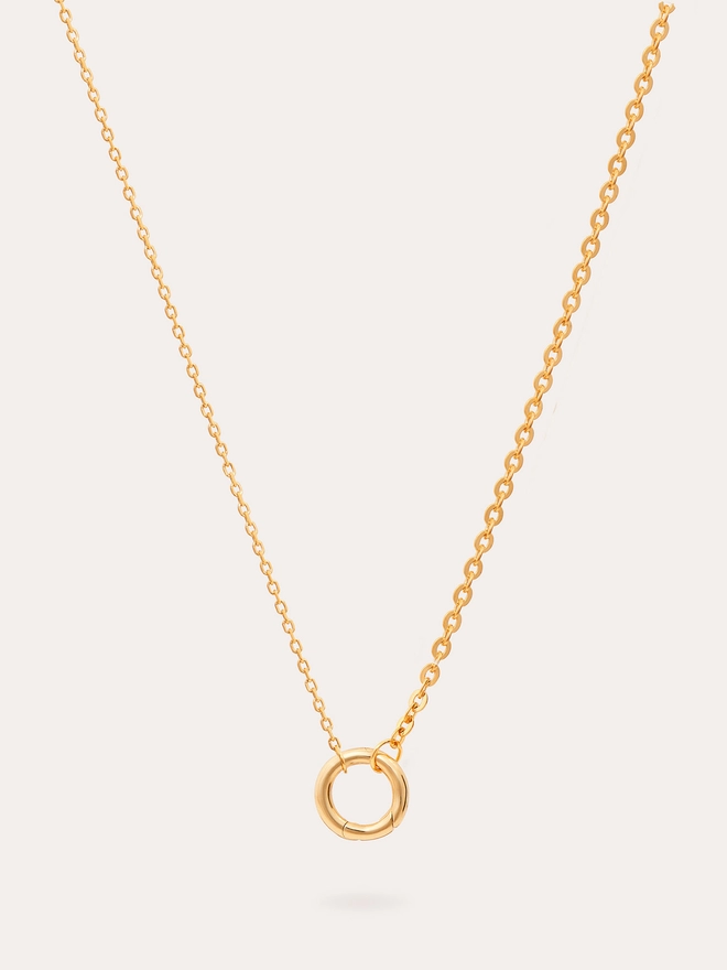 Still life image of a single link fine mixed chain gold necklace