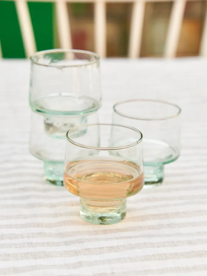Handmade Recycled Low Wine Glasses (Set Of 1 Or 4) set up on a stripped table cloth 