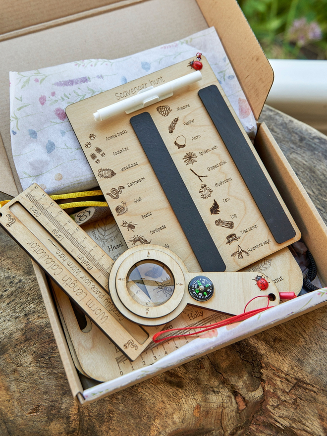 Outdoor activity kit. Wooden activity tools for a scavenger hunt with a magnifying glass