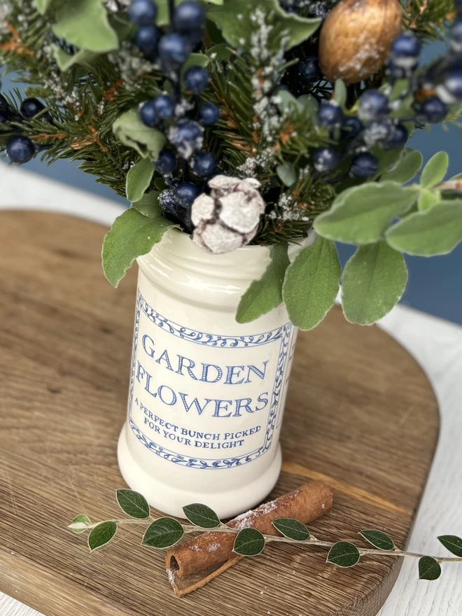 Ceramic jar with a large label say Garden Flowers printed on it