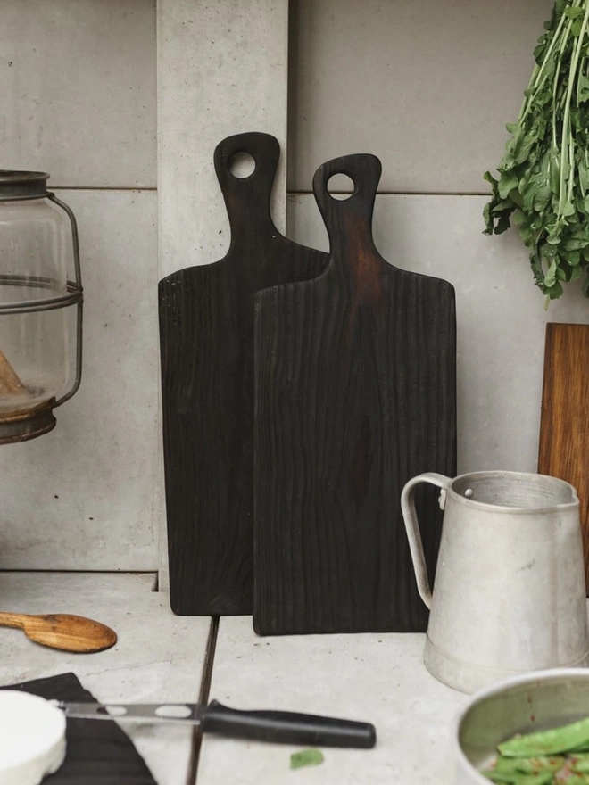 Two small Yakisugi boards standing on kitchen worktop