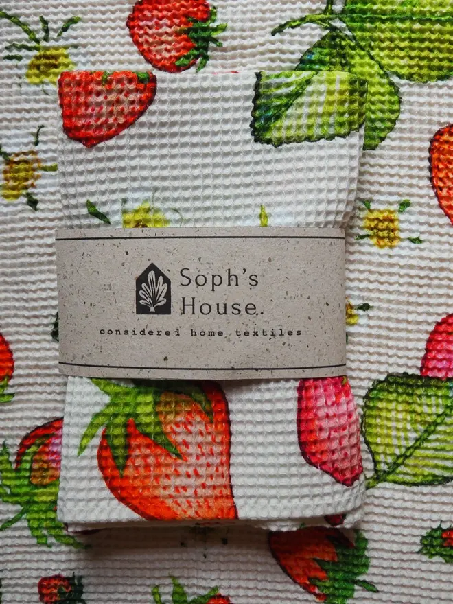 Strawberry Waffle Tea towel, folded in top of a Strawberry Waffle Tea towel. 