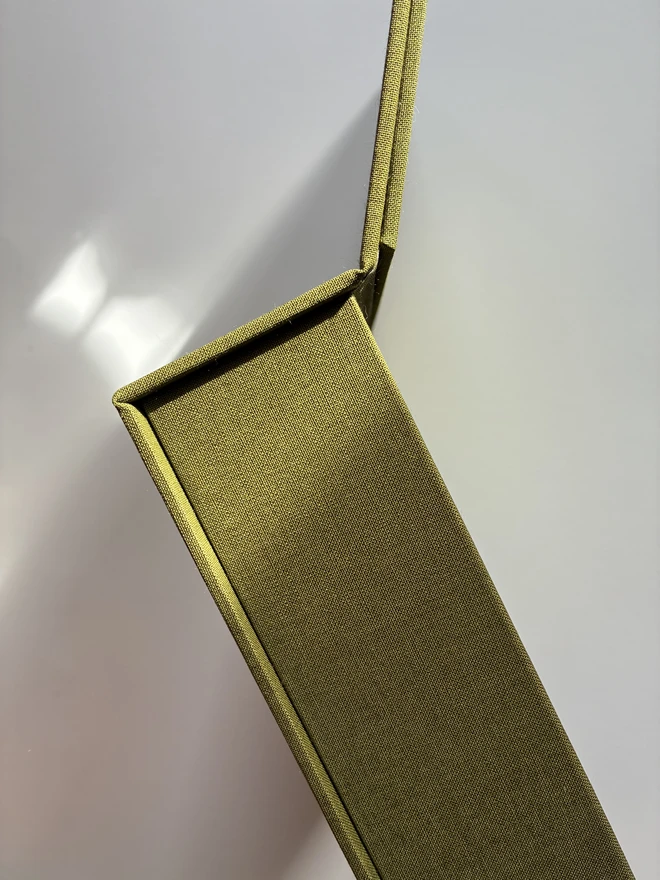 Details of open and empty handmade Christmas correspondence box covered in linen cloth with compartments