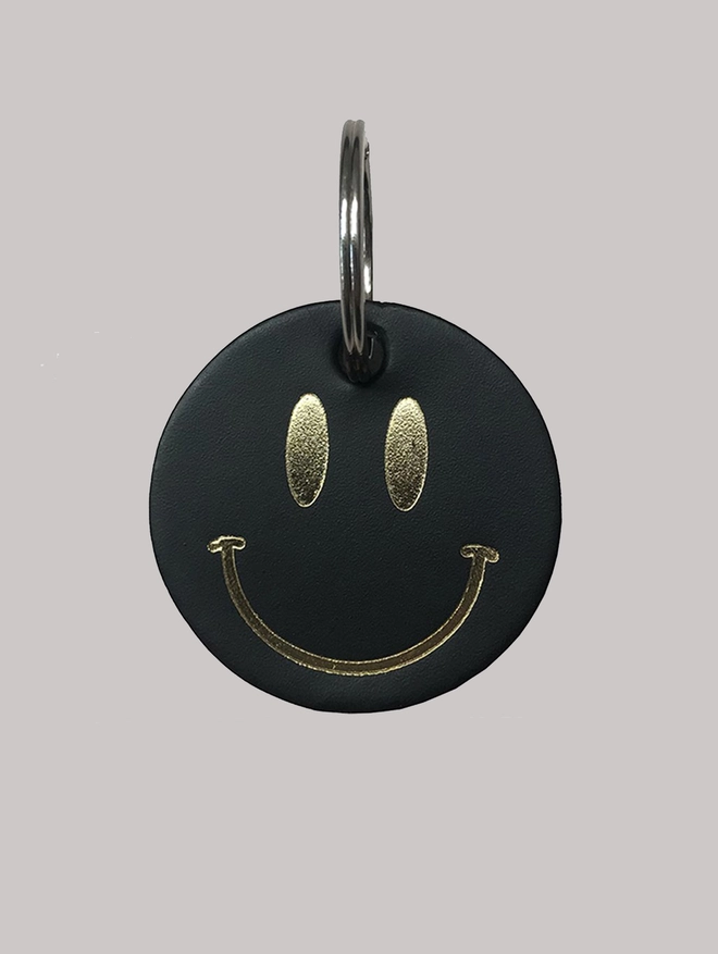 Smiley gold metallic on black leather keyring