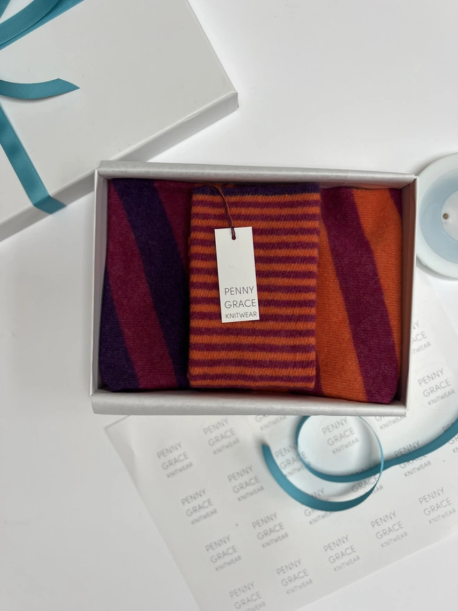 Merino wool snood in purple magenta orange displayed in gift box.