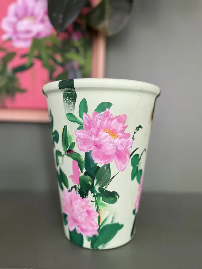hand painted floral terracotta interior plant pot pale green background pink peony flowers