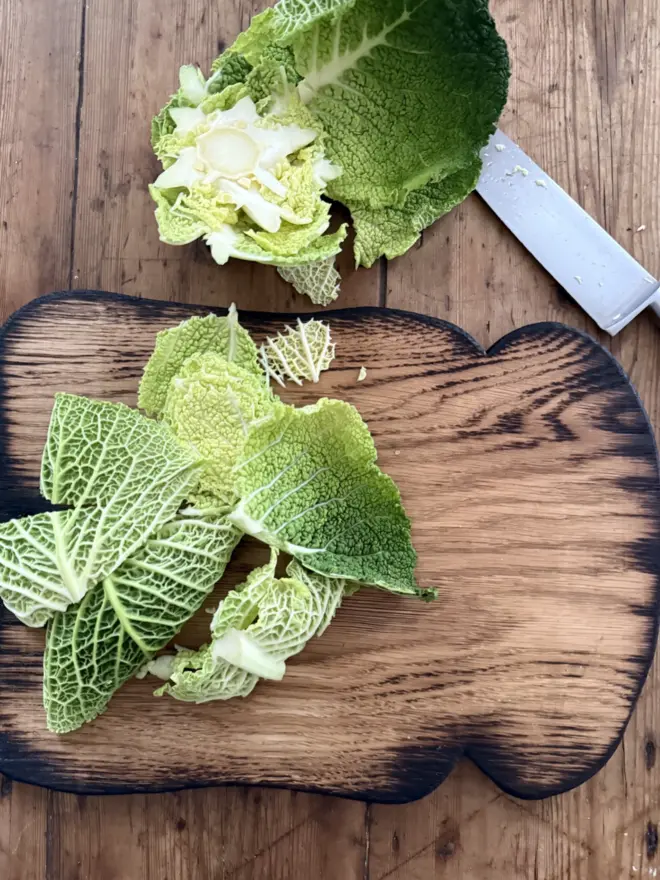 Large toast shaped oak board with charred edges with cabbage and knife 