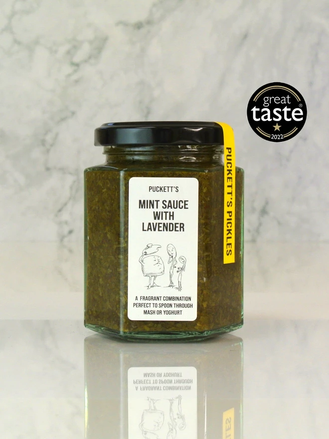 mint sauce with yorkshire lavender. a jar of mint sauce photographed on a marble background. 
