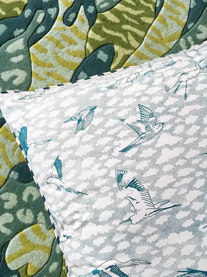 Big Cat Camo Hand Tufted Rug, a colourful rug sitting on a plain surface. 