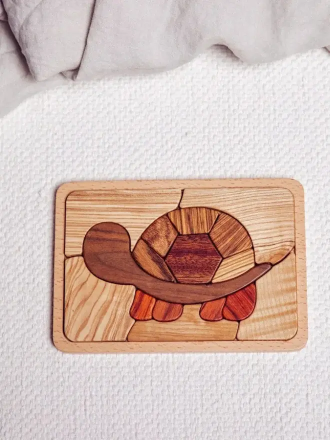 Shelly Slow Wooden Persistence Jigsaw Puzzle Heirloom Toy, on a table. 