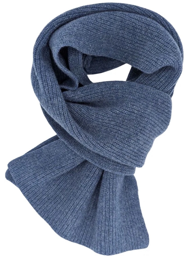 Lambswool Ribbed Scarf, a colourful ribbed scarf siting on a plain white surface. 