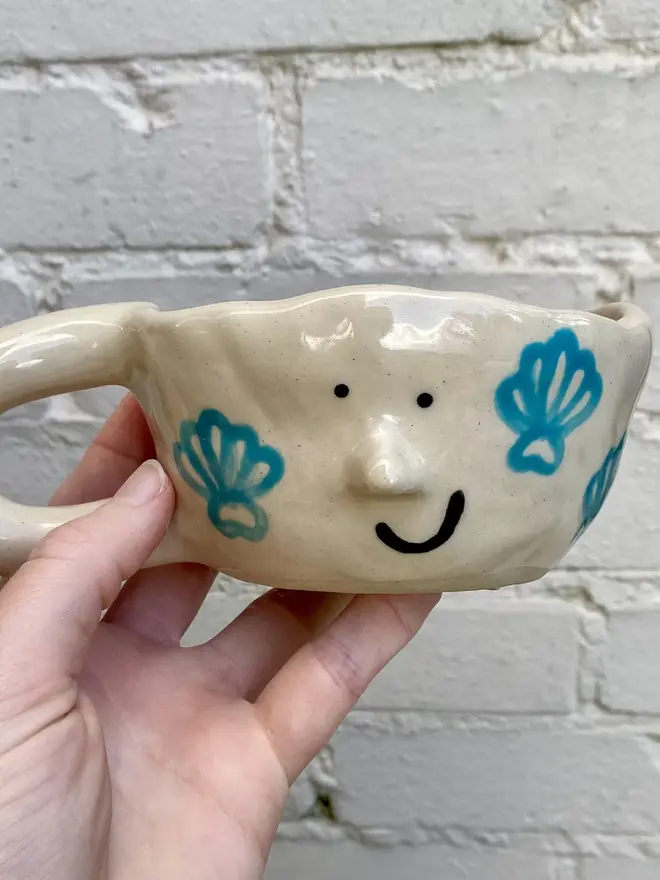 handmade ceramic smiley face shell mug