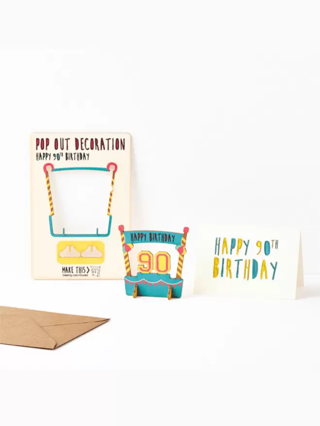 90th birthday decoration and 90th birthday card and brown kraft envelope on a white background