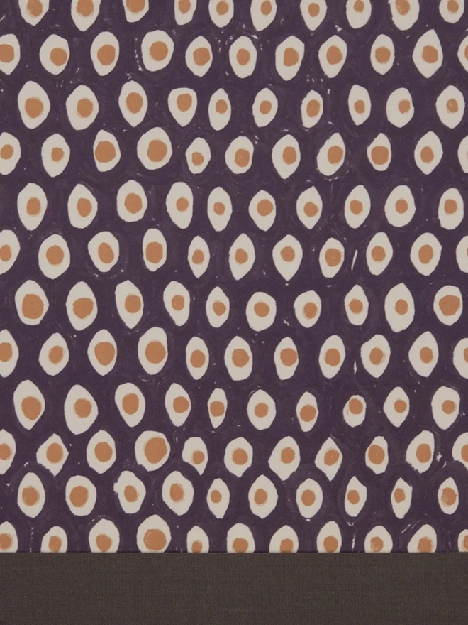 Paper Empire Lampshade. Close-up of a hand block printed lampshade showing a bold repeating geometric pattern. The colourful printed design and neat trim bring character and a handcrafted finish to any lamp.