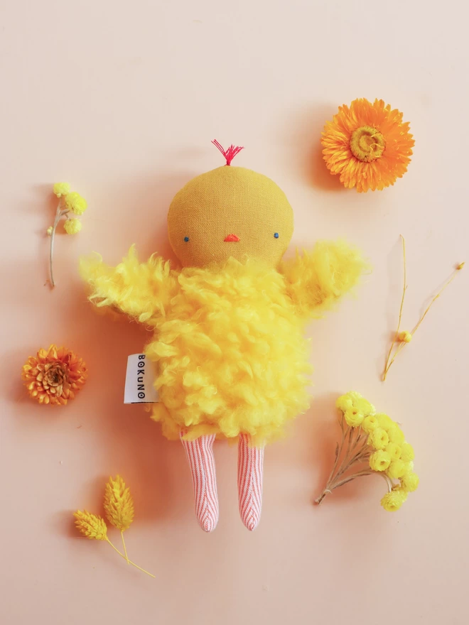 Yellow chick doll with linen head, fluffy faux fur body and orange stripe legs.