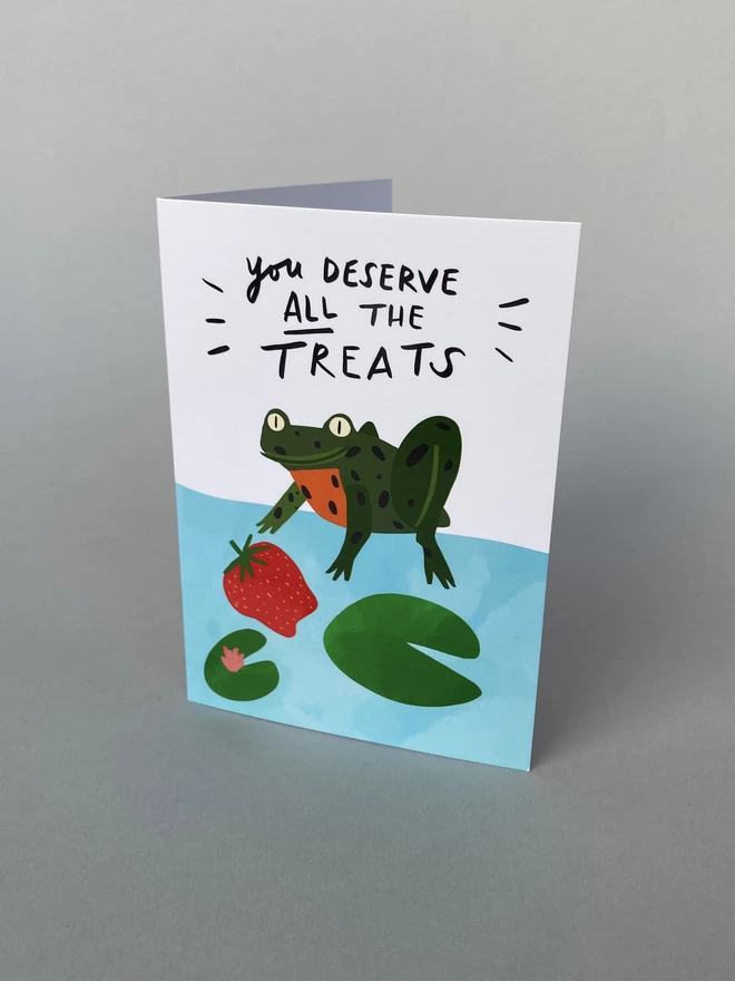 Illustrated A6 Greeting card with a green spotted frog that reads - You Deserve ALL the Treats