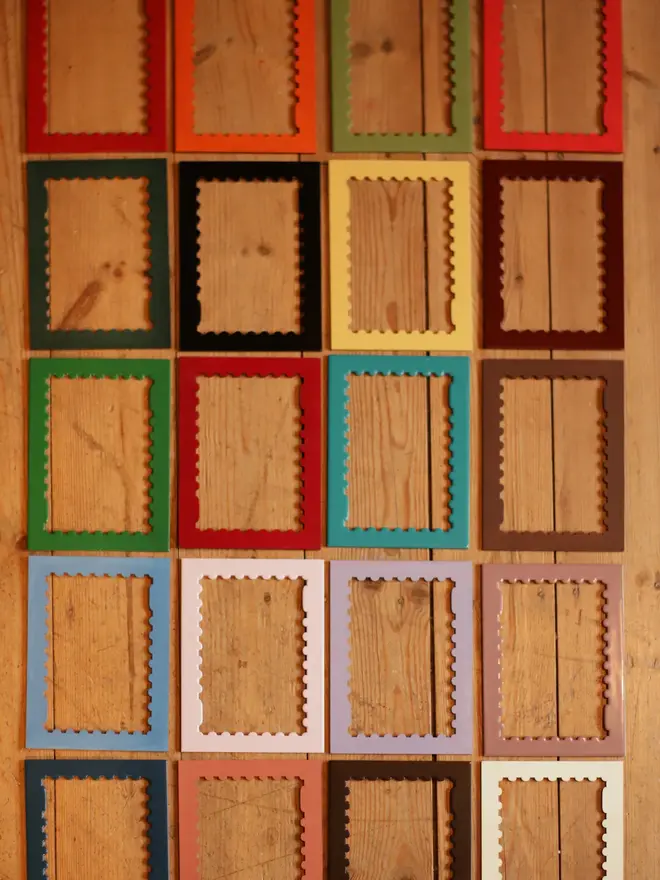 various emoty stamp shaped frame mounts lying on wooden floor