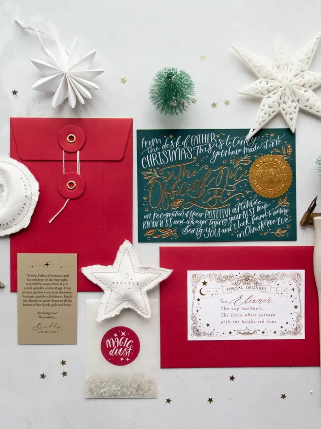 A dark green gold foil certificate with red envelopes, a Magic Dust packet and a Chief Elf note.