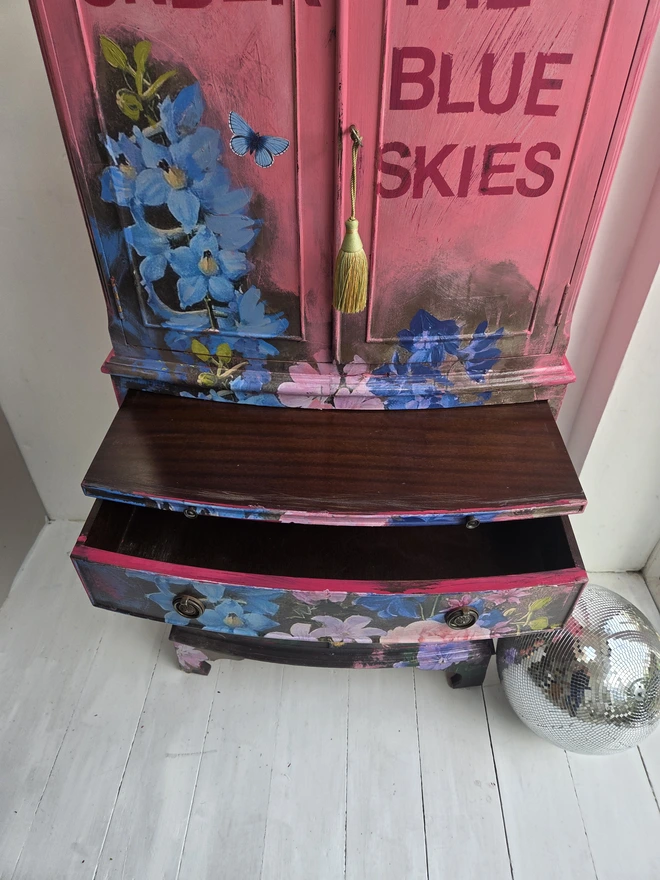 Painted vintage wooden cabinet with pink, blue and floral decoration