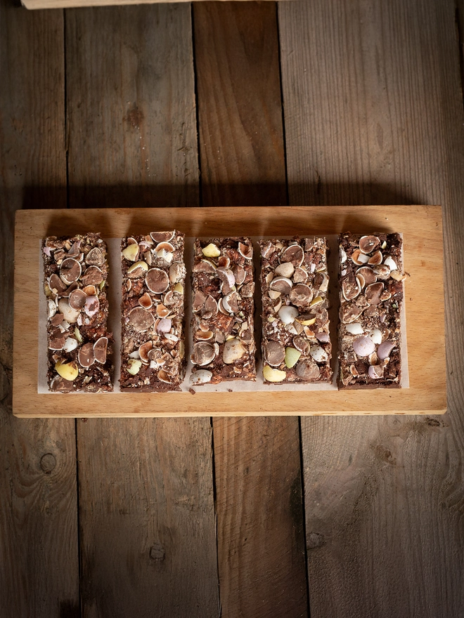 Four slices of Chocolate Rocky Road with Mini Eggs on top