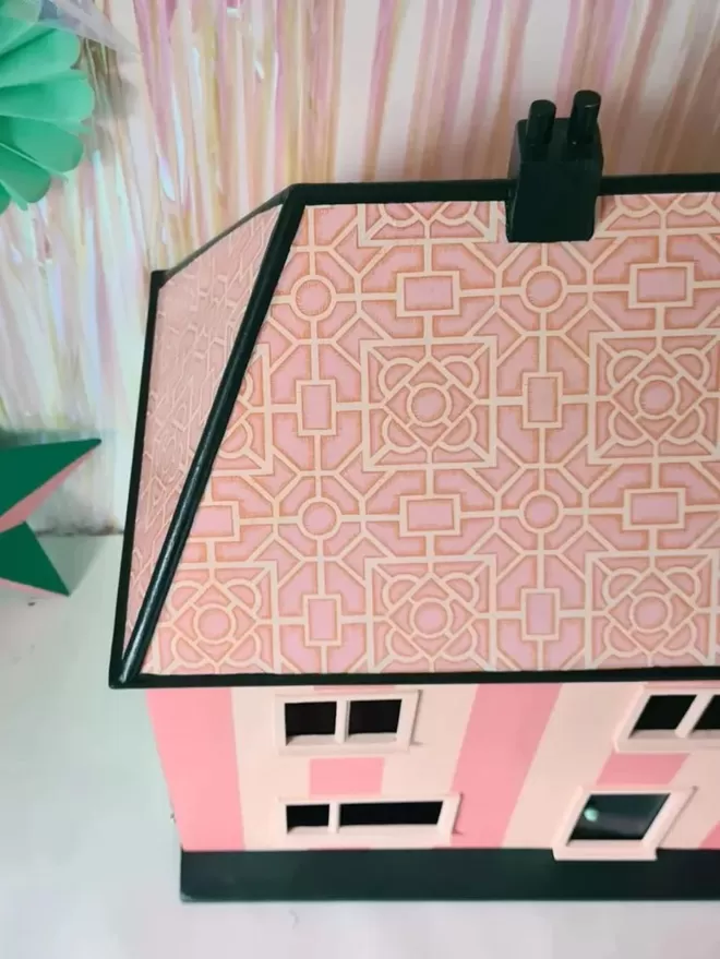 Pink striped dolls house with decoupage tiled roof