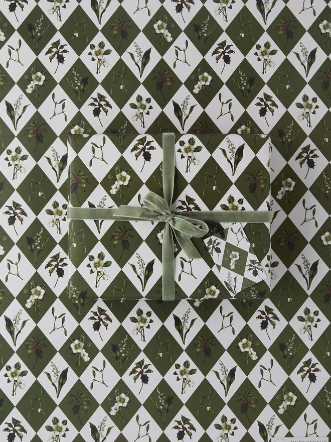 green and ivory harlequin pattern with festive botanicals wrapping paper