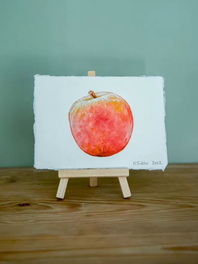 Katie Tinkler illustration of an apple seen in front of a blue wall.
